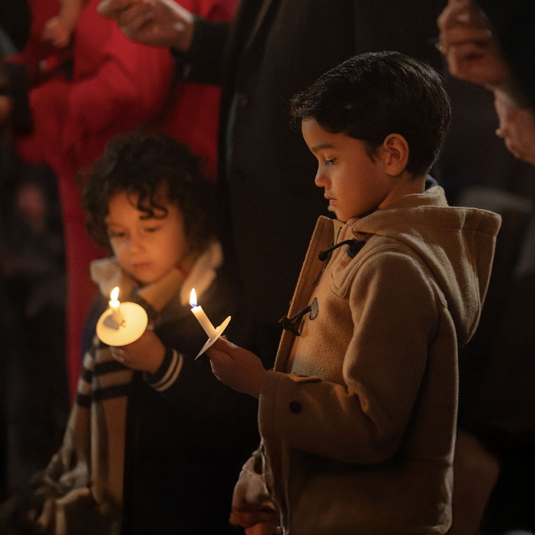 Boy and girl holding candles