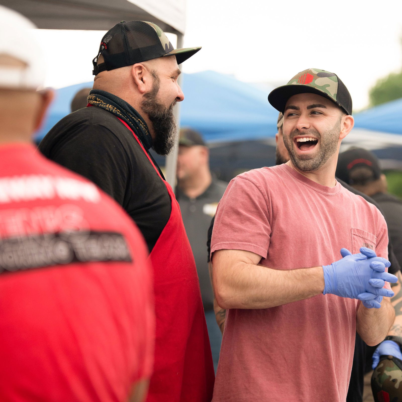 Man smiling with other men