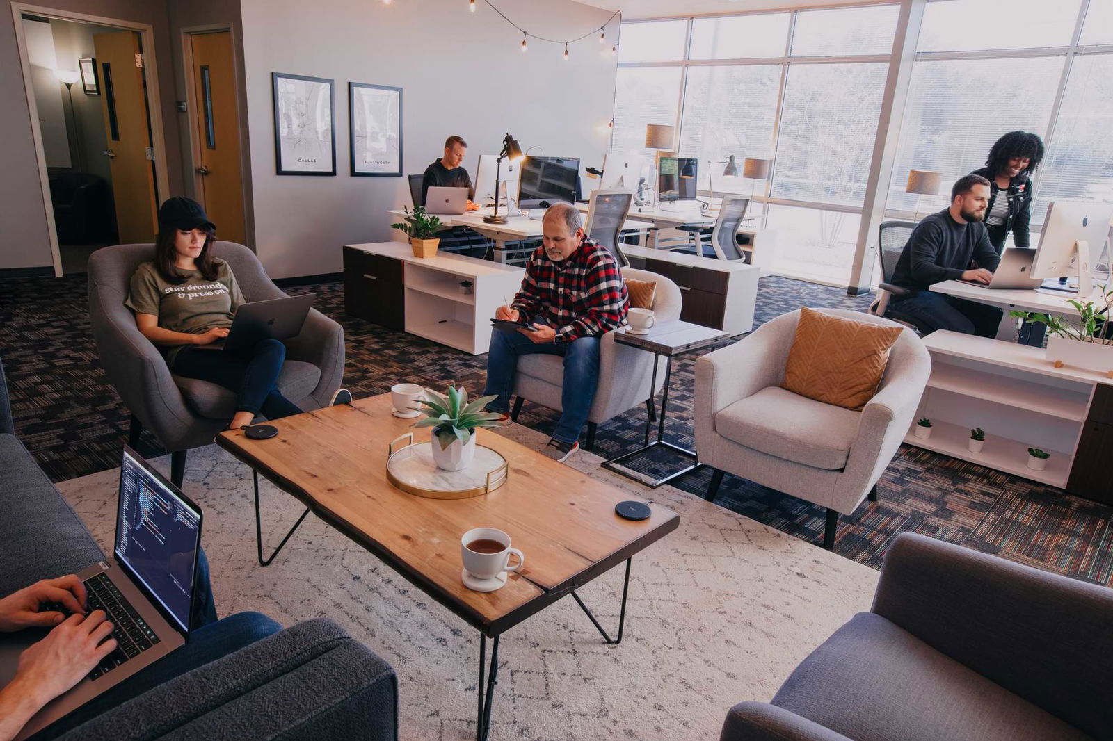 People in an office setting looking at computers
