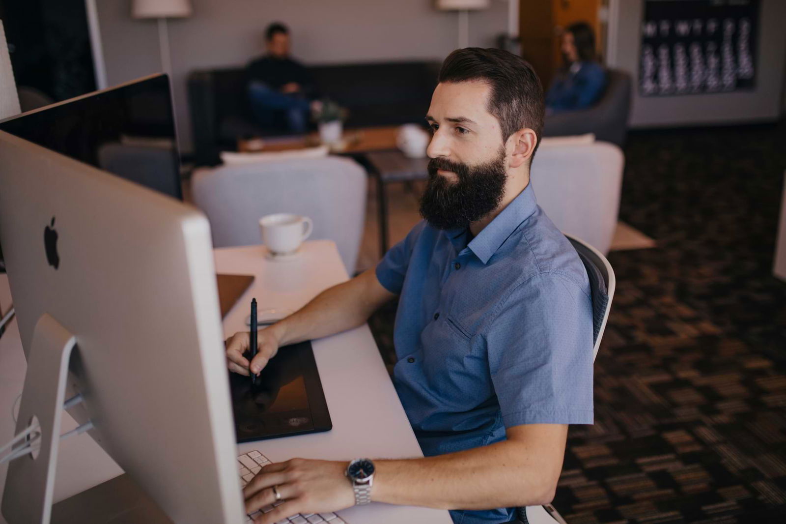 Man sitting at a computer taking notes