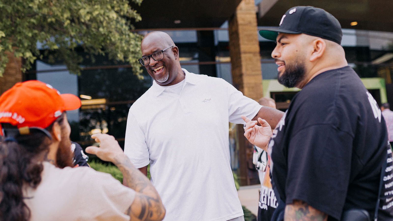 Man smiling and talking with friends